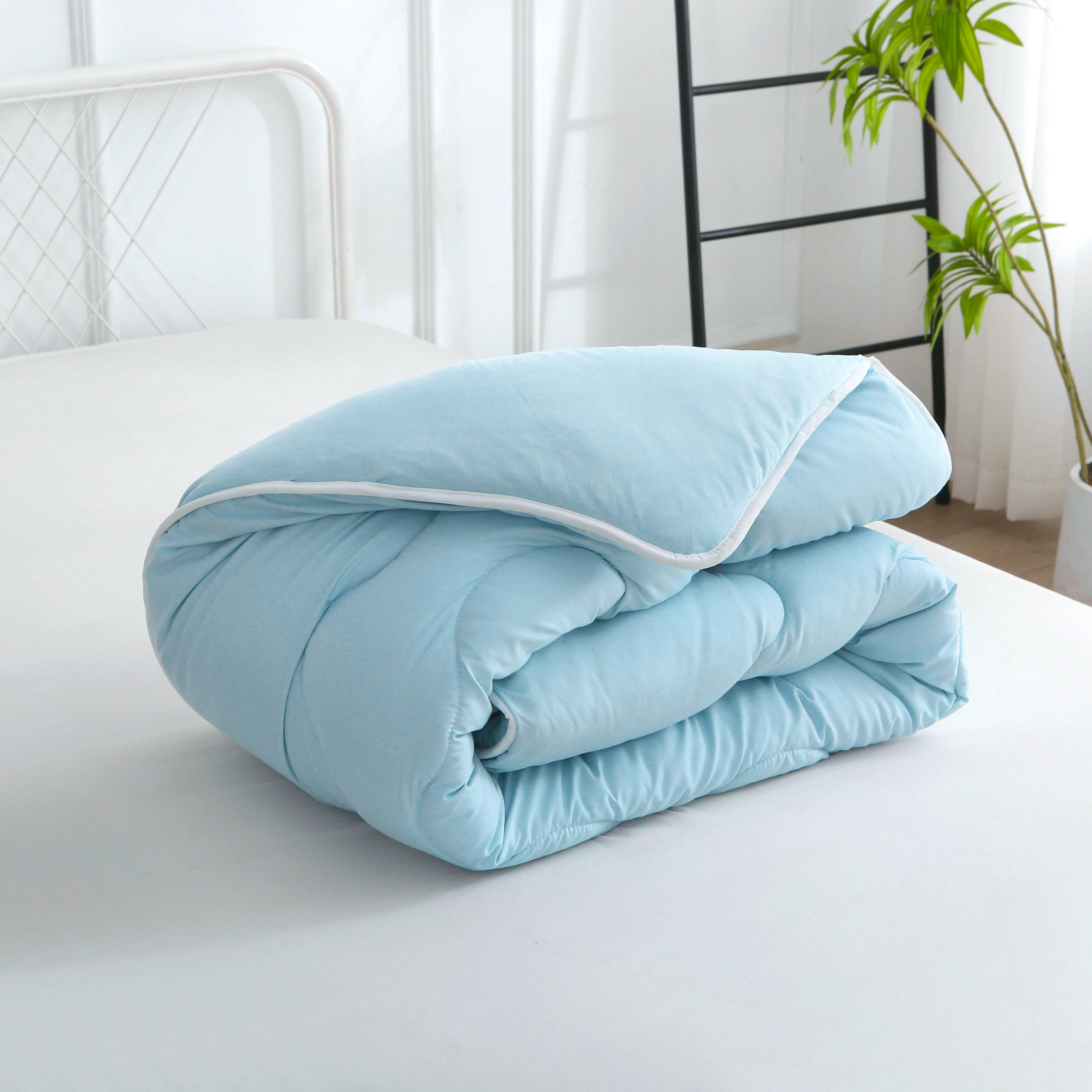 Opgevouwen blauw hoesloos dekbed met verkoelend effect en vaste hoes, licht en ademend